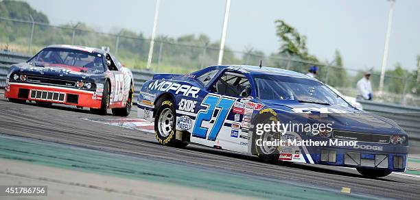 Andrew Ranger, driver of the Mopar Dodge races through a turn while ...