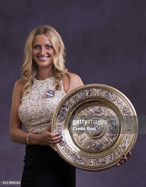 Petra Kvitova of the Czech Republic poses with the Venus Rosewater Dish trophy at the Wimbledon Championships 2014 Winners Ball at The Royal Opera...