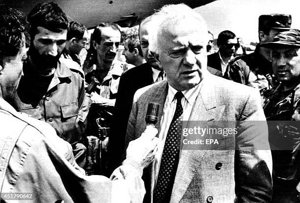 Georgian leader Eduard Shevardnadze talks to reporters near his residence after several shells landed nearby 09 July 1993, narrowly missing him....