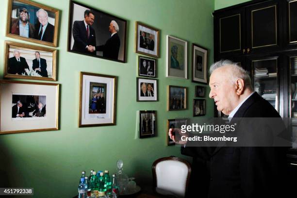 Eduard Shevardnadze, former Georgian president and Russia's former foreign minister, looks at framed photographs of World leaders hanging on the wall...