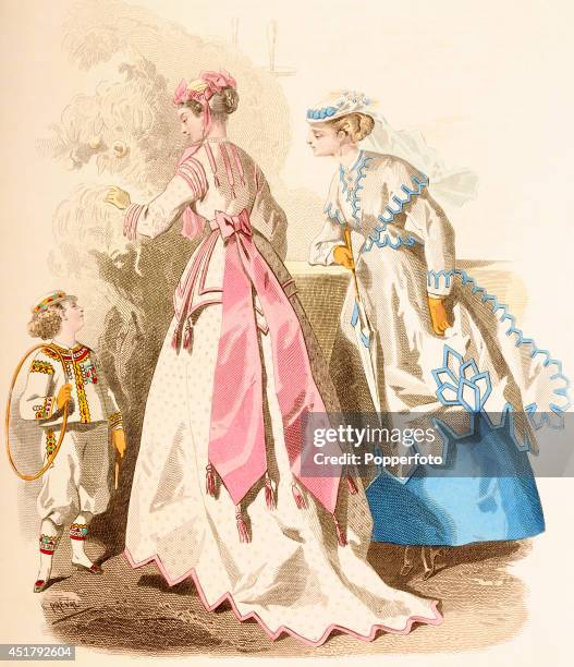 French vintage fashion illustration featuring two stylish ladies with a young boy with a hoop in a parkland setting, published in Paris, circa July...