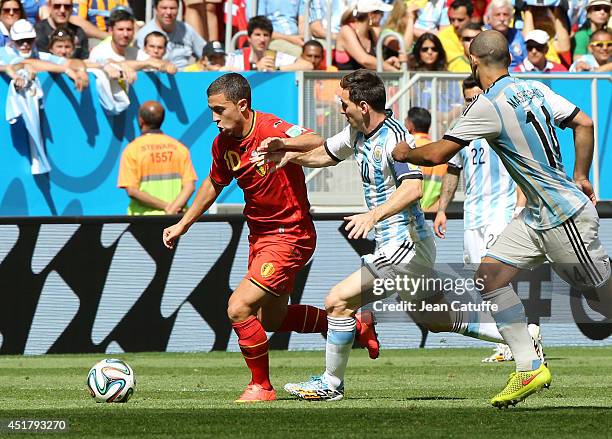 Eden Hazard of Belgium and Lionel Messi of Argentina in action during the 2014 FIFA World Cup Brazil Quarter Final match between Argentina and...