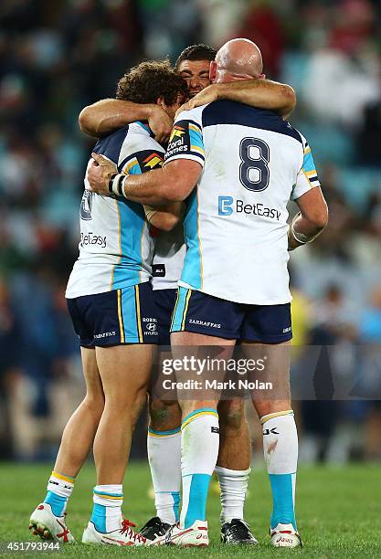 Beau Falloon, Mark Minichiello and Luke Bailey of the Titans celebrate winning the round 17 NRL match between the South Sydney Rabbitohs and the Gold...