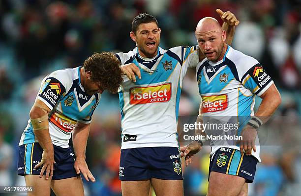 Beau Falloon, Mark Minichiello and Luke Bailey of the Titans celebrate winning the round 17 NRL match between the South Sydney Rabbitohs and the Gold...