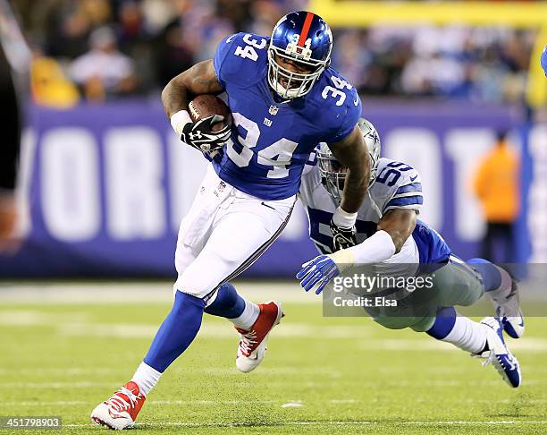 Brandon Jacobs of the New York Giants carries the ball as Ernie Sims of the Dallas Cowboys tries to make the tackle at MetLife Stadium on November...