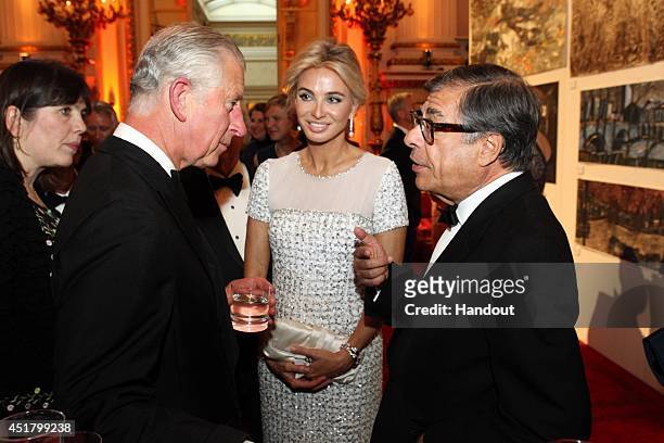 In this handout provided by Paul Burns, Prince Charles, Prince of Wales greets Corinna zu Sayn-Wittgenstein and Bob Colacello at a fund raising event...