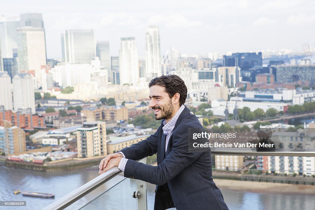 Man overlooking city from elevated view.