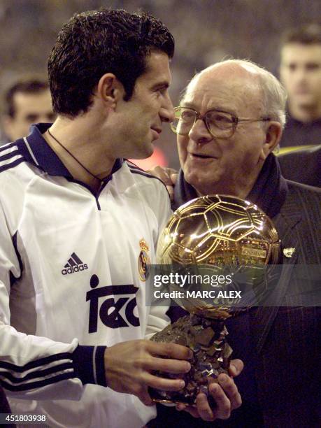 Real de Madrid Portuguese Luis Figo talks to foprmer player Alfredo Di Stefano, holding the gold ball before a League match between Real Madrid and...