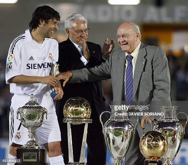 Real Madrid's legend and Honor President Alfredo Di Stefano poses with the trophies won with Real Madrid next to Real Madrid interim President Luisa...