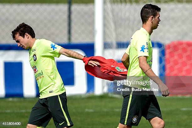 Bernard and Oscar take part during a training session of the Brazilian national football team at the squad's Granja Comary training complex, on July...