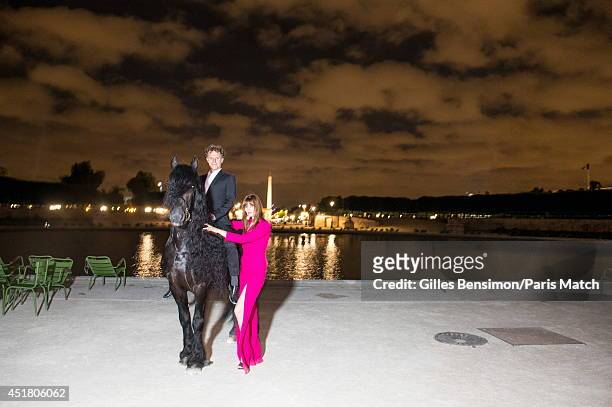 Charles Berling and Marina Hands are photographed for Paris Match at the start of the Longines Global Champions Tour Paris Eiffel on June 26, 2014 in...