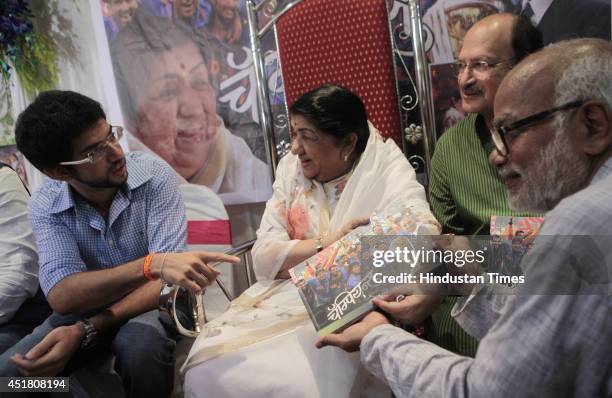 Shivsena leader Aditya Thackray, Veteran singer Lata Mangeshkar and former cricketer Ajit Wadekar during the launch of book, Champion authored by...