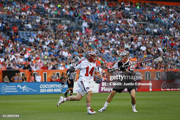 Ryan Boyle of the Boston Cannons in action against Lee Zink of the Denver Outlaws at Sports Authority Field at Mile High on July 4, 2014 in Denver,...