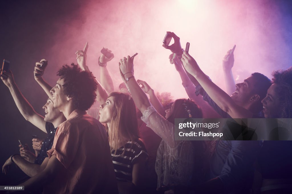 Group of people having fun at music concert