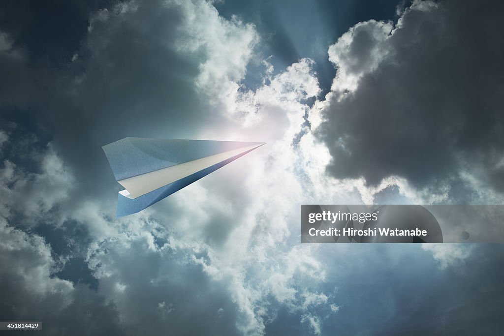 Paper airplane flying in the sky