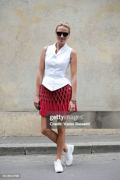 Inga Kozel poses wearing Azzedina Alaia Couture top and skirt, Chanel Couture shoes and Chanel clutch after Dior show on July 7, 2014 in Paris,...