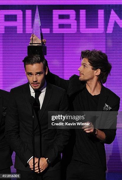 Singers Liam Payne and Louis Tomlinson of One Direction accept the Favorite Pop/Rock Album award for 'Take Me Home' onstage during the 2013 American...