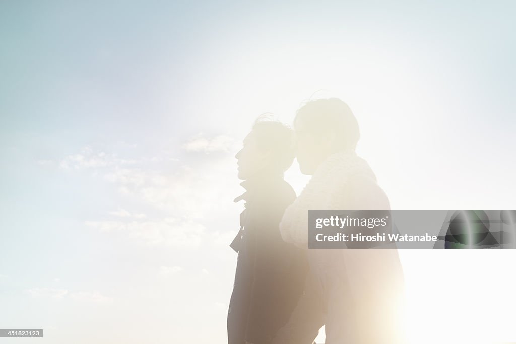 Couple walking on the pavement at sunset