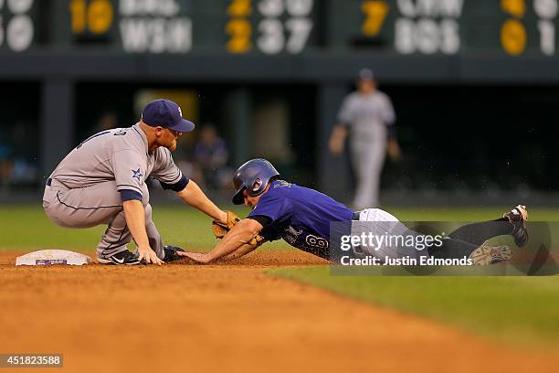 Second baseman Brooks Conrad of the San Diego Padres applies the tag as Michael McKenry of the Colorado Rockies is caught stealing during the fifth...