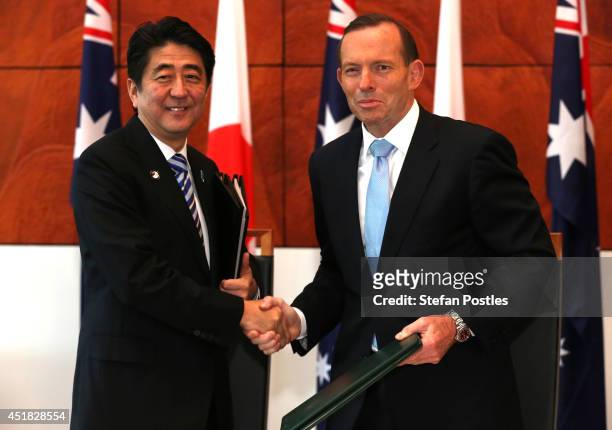 Japanese Prime Minister Shinzo Abe and Australian Prime Minister Tony Abbott shake hands after signing the Japan-Australia Economic Partnership...