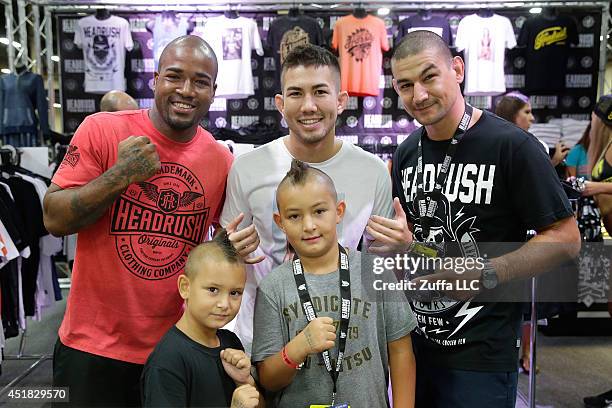 Bobby Green, Louis Smolka and Vinc Pichel pose with fans during the UFC Fan Expo 2014 during UFC International Fight Week at the Mandalay Bay...