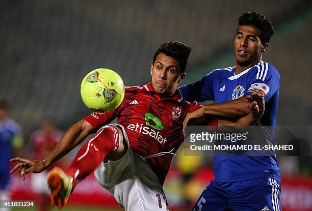 Egyptian player of al-Ahly club Amr Gamal fights for the ball with Farid al-Sayed from Smouha club during their football match in the final of Egypts...