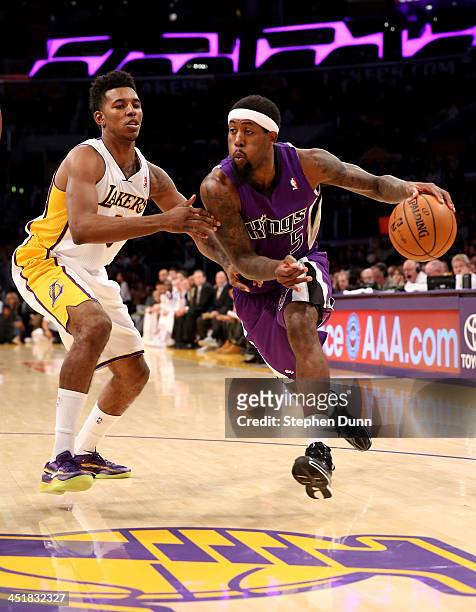 John Salmons of the Sacramento Kings drives past Nick Young of the Los Angeles Lakers at Staples Center on November 24, 2013 in Los Angeles,...