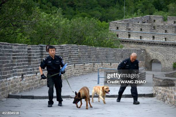 Two policeman patrol The Great Wall of China during a visit by US Secretary of State John Kerry and US Secreary of the Treasury Jacob Lew at...