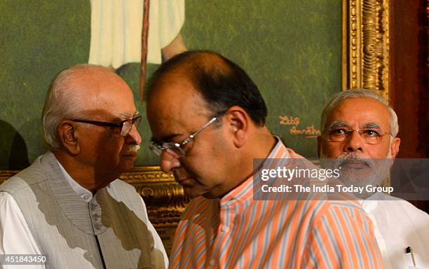 Prime Minister Narender Modi with Senior Bharatiya Janata Party leader L K Advani and Union Minister Arun Jaitely at Parliament to celebrate the...