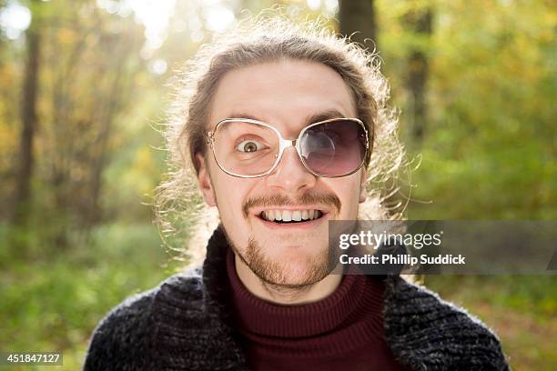 scruffy boy with broken glasses pulling funny face - brille kaputt stock-fotos und bilder