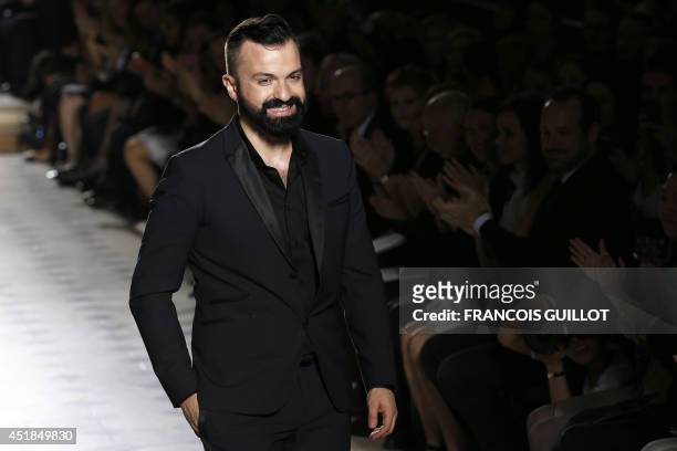 French fashion designer Julien Fournie acknowledges the public at the end of his 2014/2015 Haute Couture Fall-Winter collection fashion show on July...
