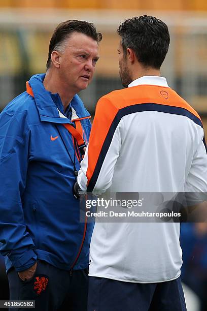 Head coach, Louis van Gaal speaks to Robin van Persie during the Netherlands training session at the 2014 FIFA World Cup Brazil held at the Estadio...