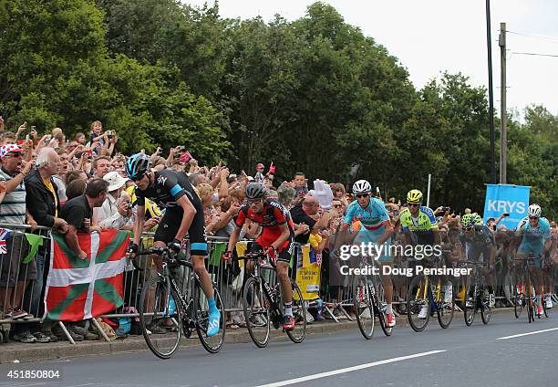 Chris Froome of Great Britain and Team Sky leads the race as he attacks on the final climb and claims the points at the top of the Cote de Jenkins...