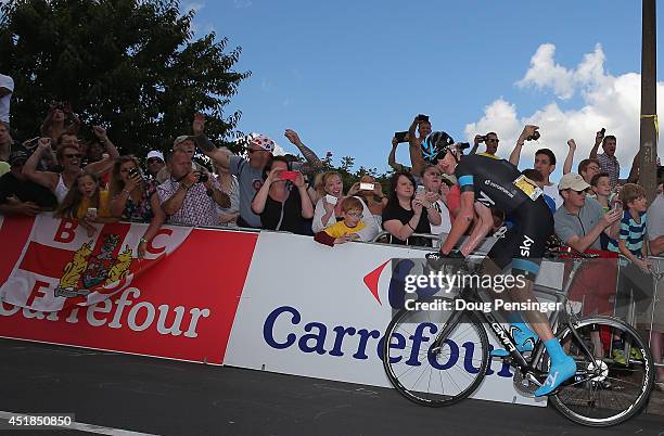 Chris Froome of Great Britain and Team Sky leads the race as he attacks on the final climb and claims the points at the top of the Cote de Jenkins...