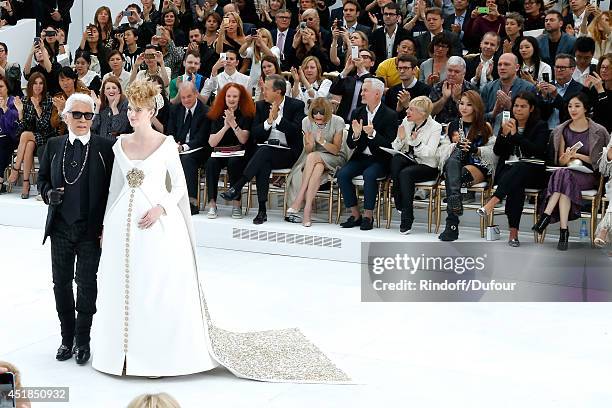 Fashion Designer Karl Lagerfeld and pregnant model walk the runway front of Suzy Menkes, Carine Roitfeld, Grace Coddington, Mario Testino, Anna...