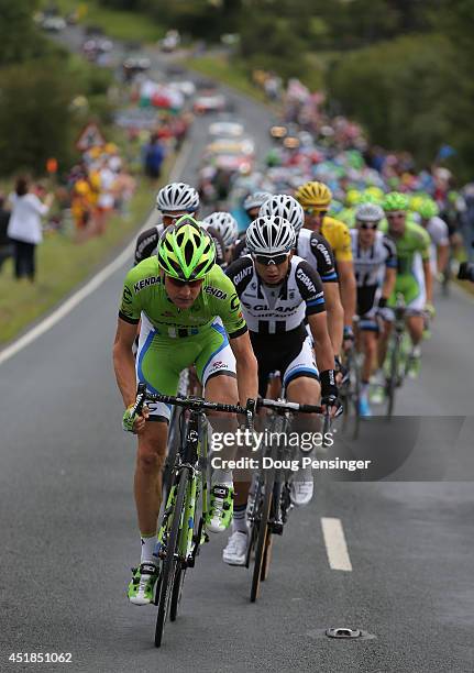 Ted King of the United States and Cannondale drives the front of the peloton and is followed by Ji Cheng of China and Team Giant-Shimano durign stage...