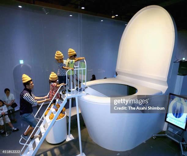 Children play at the 5-meter-tall toilet shaped slider during the 'Toilet!? Human Waste and Earth's Future' exhibition at The National Museum of...