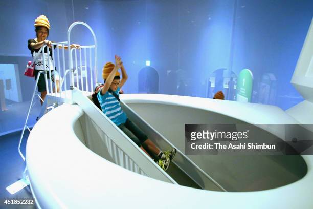 Children play at the 5-meter-tall toilet shaped slider during the 'Toilet!? Human Waste and Earth's Future' exhibition at The National Museum of...