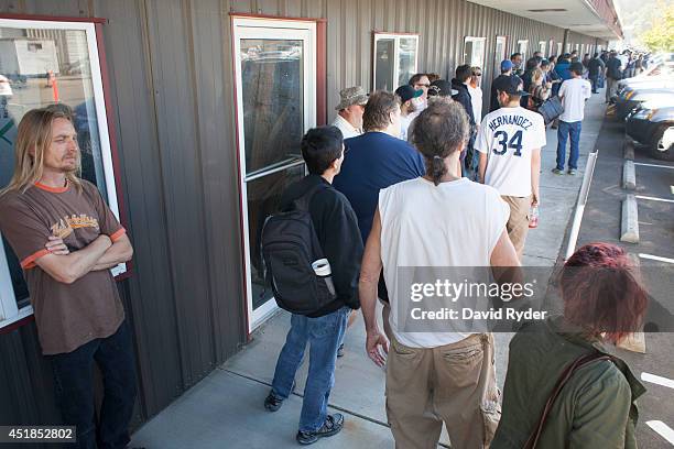 Customers wait in line at Top Shelf Cannabis, a retail marijuana store, on July 8, 2014 in Bellingham, Washington. Top Shelf Cannabis was the first...