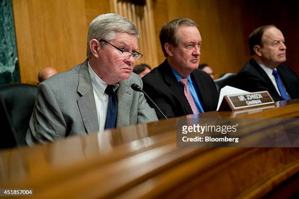 Senator Tim Johnson, a Democrat from South Dakota and chairman of the Senate Banking Committee, from left, Senator Mike Crapo, a Republican from...