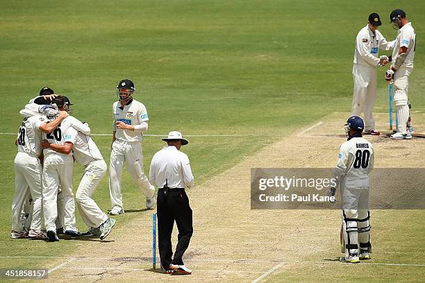 Marcus North of the Warriors is congratulated by team mates after dismissing John Hastings of the Bushrangers to claim victory on day four of the...