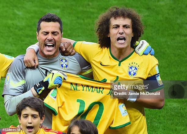Goalkeeper Julio Cesar and David Luiz of Brazil hold a Neymar jersey as they sing the National Anthem prior to the 2014 FIFA World Cup Brazil Semi...