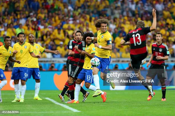 Thomas Mueller of Germany scores his team's first goal during the 2014 FIFA World Cup Brazil Semi Final match between Brazil and Germany at Estadio...