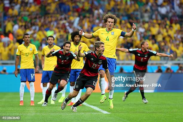 Thomas Mueller of Germany celebrates scoring his team's first goal during the 2014 FIFA World Cup Brazil Semi Final match between Brazil and Germany...