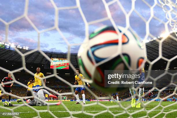 Miroslav Klose of Germany scores his team's second goal past Julio Cesar of Brazil during the 2014 FIFA World Cup Brazil Semi Final match between...