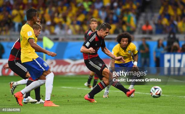 Miroslav Klose of Germany scores his team's second goal during the 2014 FIFA World Cup Brazil Semi Final match between Brazil and Germany at Estadio...
