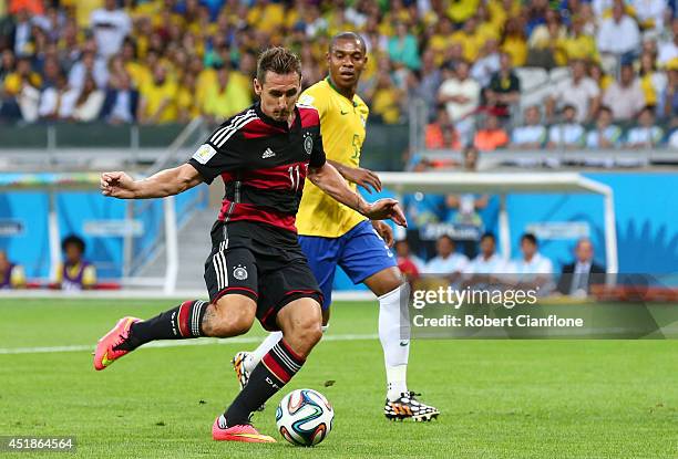 Miroslav Klose of Germany shoots and scores his team's second goal during the 2014 FIFA World Cup Brazil Semi Final match between Brazil and Germany...