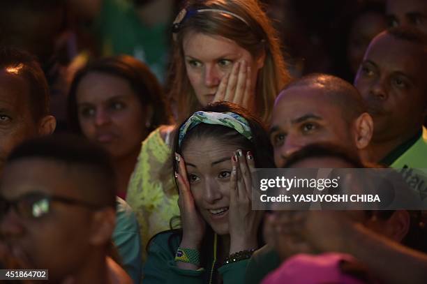 Brazil's fans show their disapointment at a street of Rio de Janeiro, during the semi-final football match between Brazil and Germany --being held at...
