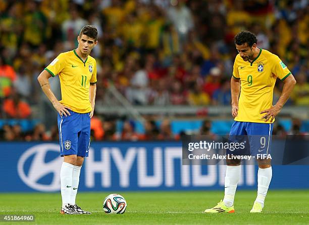Oscar and Fred of Brazil react after conceding fourth goal to Germany during the 2014 FIFA World Cup Brazil Semi Final match between Brazil and...