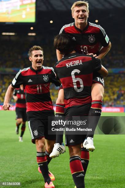 Toni Kroos of Germany celebrates scoring his team's fourth goal and his second of the game with teammates Miroslav Klose and Sami Khedira during the...